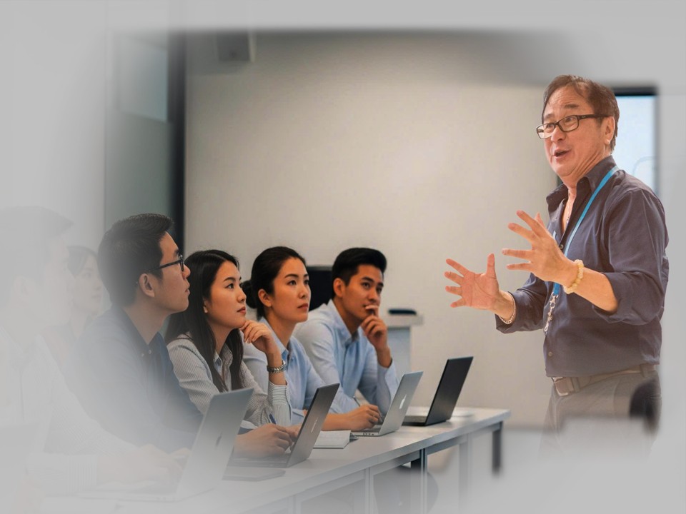 Professional testing instructor collaborating with learners in a workshop